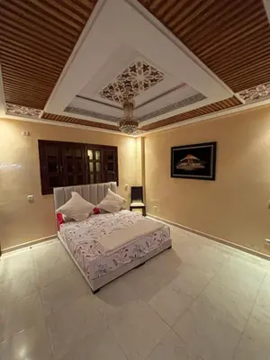 a bedroom with a bed and a coffered ceiling at Villa Saber in Marrakech