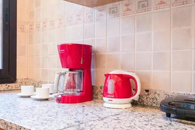 a red and white coffeemaker sitting on a kitchen counter at Your Traditional Marrakchi Villa in Marrakech