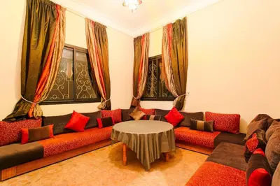 a living room with a couch and a table at Your Traditional Marrakchi Villa in Marrakech