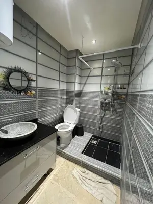a bathroom with a toilet and a sink at Cozy apartment center Gueliz in Marrakech