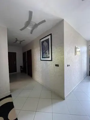 a living room with a ceiling fan and a tile floor at Villa Marrakech in Marrakech