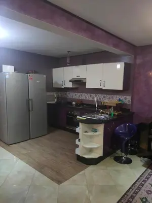 a kitchen with a stainless steel refrigerator and a counter at Said MM in Marrakech