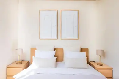 a bedroom with two pictures on the wall and a bed at Appartement prestigia golf accès piscine in Marrakech
