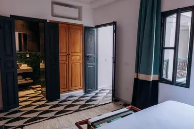 a room with doors and a checkered floor at Riad Beltza - 