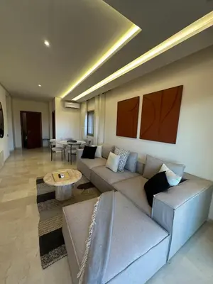 a living room with a couch and a table at Apparemment haute standing golf prestigia in Marrakech