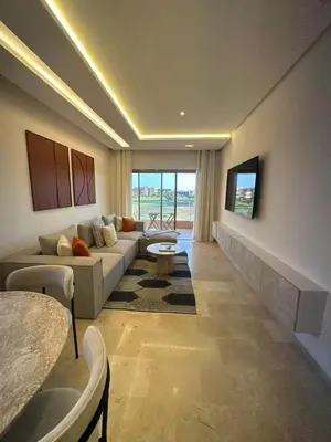 a living room with a couch and a table at Apparemment haute standing golf prestigia in Marrakech