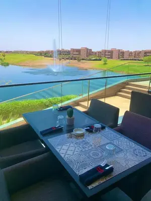 a table in a room with a view of the water at Apparemment haute standing golf prestigia in Marrakech