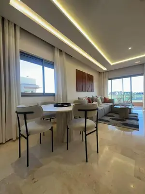 a living room with a couch and tables and chairs at Apparemment haute standing golf prestigia in Marrakech