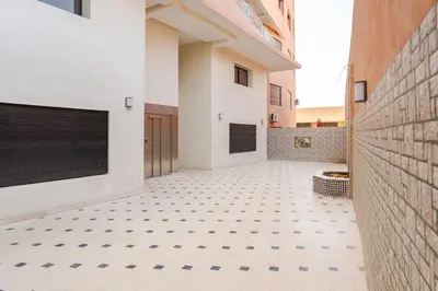 a hallway of a building with a tiled floor at Cosy appartement au centre ville hivernage marrakech in Marrakech
