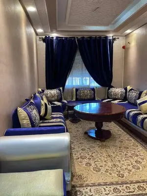 a living room with a couch and a table at Appartement à louer Marrakech tous les services in Marrakech