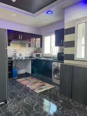 a kitchen with purple cabinets and a washing machine at Appartement à louer Marrakech tous les services in Marrakech