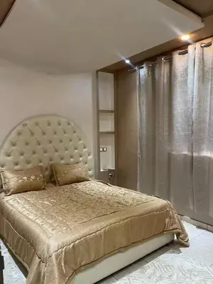 a bedroom with a large bed with a large headboard at Appartement à louer Marrakech tous les services in Marrakech