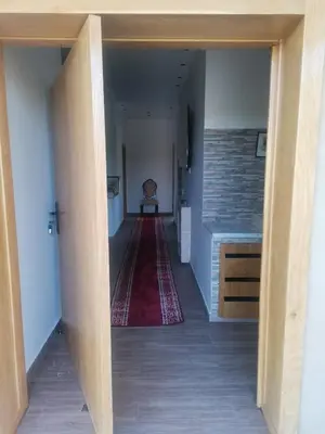 a hallway with a red rug and a table at Villa Zaina in Marrakech