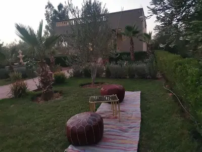 a garden with a bench and two balls on the grass at Villa Zaina in Marrakech