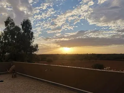 a view of the sunset from the balcony of a house at Villa Zaina in Marrakech