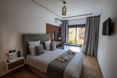 a dog laying on a bed in a bedroom at Golden Palm Resort in Marrakech