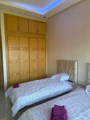 two beds in a bedroom with two closets at villa Marrakesh in Marrakech