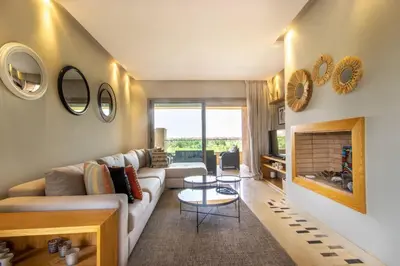 a living room with a couch and a fireplace at Stylish In Prestigia Area Pool View in Marrakech