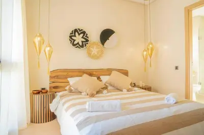 a bedroom with a large bed with two pillows at Wonderfull Place in Marrakech - Pool Wifi Terrace in Marrakech
