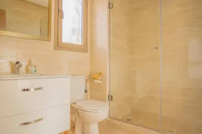a bathroom with a toilet and a glass shower at Wonderfull Place in Marrakech - Pool Wifi Terrace in Marrakech