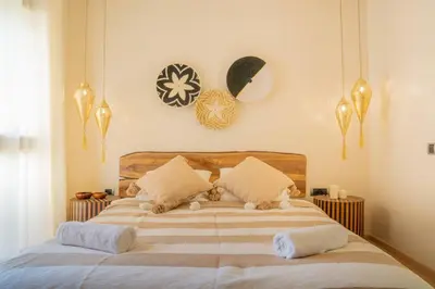 a bedroom with a bed with two cats laying on it at Wonderfull Place in Marrakech - Pool Wifi Terrace in Marrakech