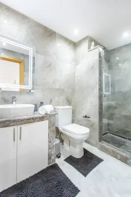 a bathroom with a toilet and a sink and a shower at Cosy Appt au Coeur de Gueliz in Marrakech