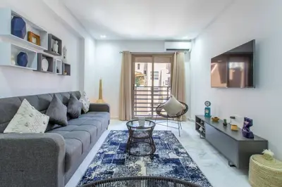 a living room with a couch and a table at Cosy Appt au Coeur de Gueliz in Marrakech
