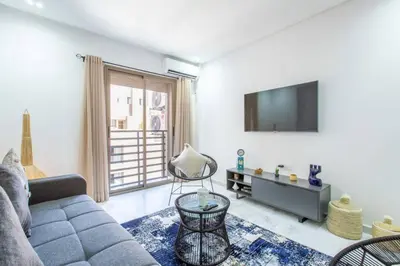 a living room with a couch and a tv at Cosy Appt au Coeur de Gueliz in Marrakech