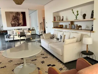 a living room with a white couch and a table at Villa Sissi Marrakech in El Rhechat