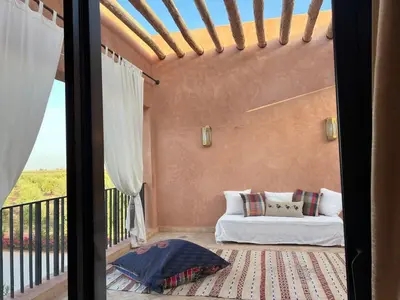 a living room with a couch on a balcony at Villa Sissi Marrakech in El Rhechat