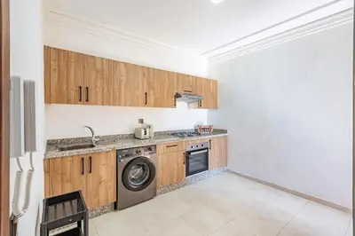 a kitchen with a washer and a washing machine at New! appt Nour Confort avec piscine & wifi in Marrakech