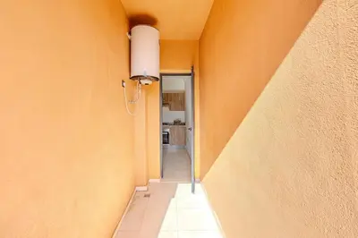 a hallway with an orange wall with a light on it at New! appt Nour Confort avec piscine & wifi in Marrakech