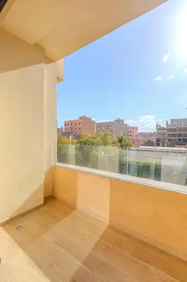 an empty room with a large window with a view at New! appt Nour Confort avec piscine & wifi in Marrakech