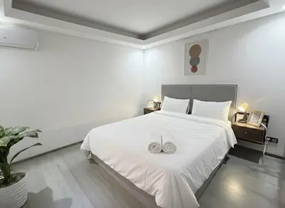 a bedroom with a white bed with two white towels on it at Ruby in Marrakech
