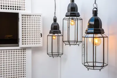 a group of three pendant lights hanging from a wall at Riad Dar Jamila Breakfast 10mn to Jamaa Al Fna in Marrakech