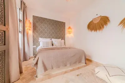 a bedroom with a large bed with white pillows at Riad Dar Jamila Breakfast 10mn to Jamaa Al Fna in Marrakech