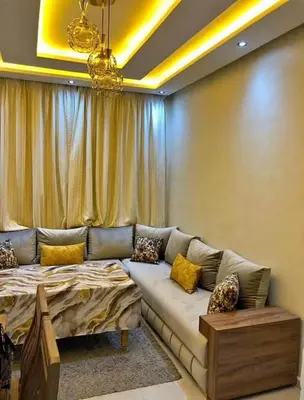 a living room with a couch and a bed at Apparetement 2 chambres in Marrakech