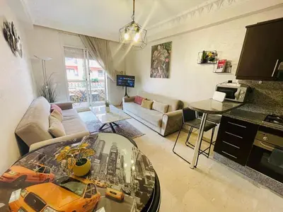 a living room with a couch and a table at Apparetement 2 chambres in Marrakech