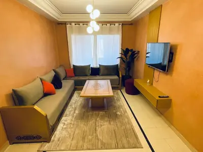 a living room with a couch and a table at Gueliz center with pool and parking in Marrakech
