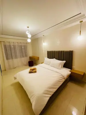 a large white bed with two teddy bears on it at Gueliz center with pool and parking in Marrakech