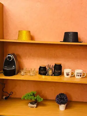 a shelf with cups and mugs on it at Gueliz center with pool and parking in Marrakech