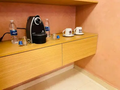 a coffee maker sitting on top of a wooden counter at Gueliz center with pool and parking in Marrakech