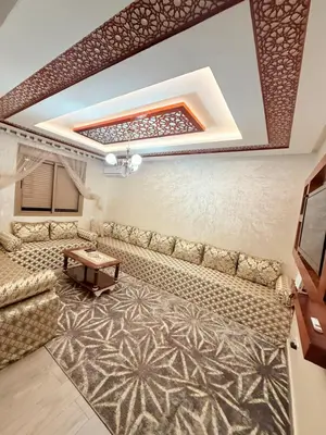a living room with a couch and a table at Appartement Calme Parfait & Centre-ville in Marrakech