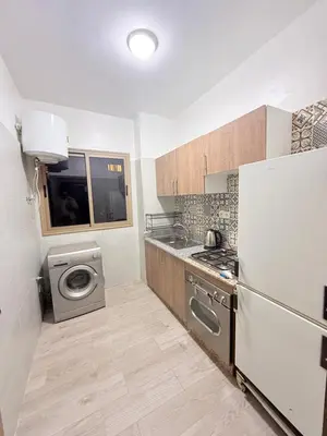 a kitchen with a refrigerator and a washing machine at Appartement Calme Parfait & Centre-ville in Marrakech