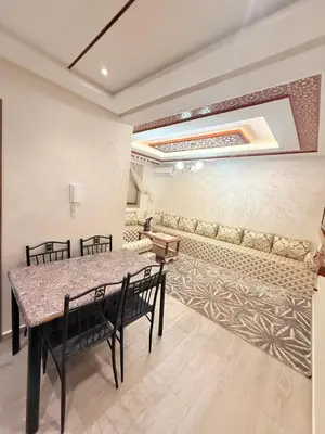 a dining room with a table and chairs at Appartement Calme Parfait & Centre-ville in Marrakech