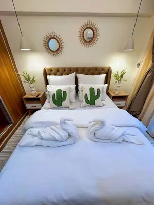 a bedroom with a bed with two towels on it at Appartement luxe au cœur de Marrakech in Marrakech
