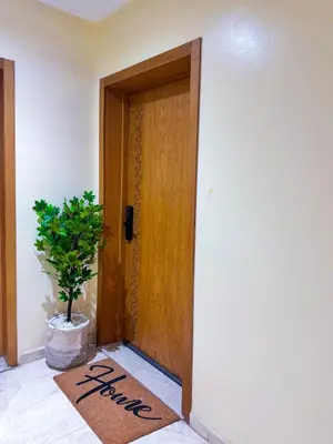 a welcome mat in front of a door with a plant at Appartement luxe au cœur de Marrakech in Marrakech
