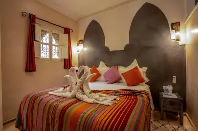 a bedroom with a bed with a stuffed animal on it at Dar Flora in Marrakech