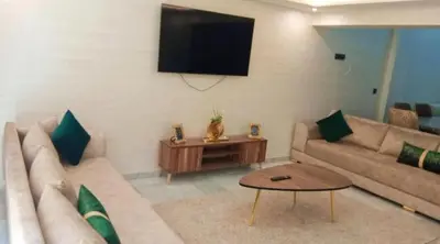 a living room with a couch and a table at Luxury Family Duplex in the Best Area of Marrakech with Pool and Garden in Marrakech