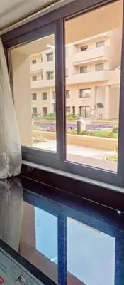 a window with a view of a building at Luxury Family Duplex in the Best Area of Marrakech with Pool and Garden in Marrakech